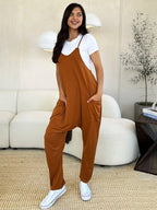 Women's sleeveless V-neck wide-leg jumpsuit with pockets, casual women's apparel by Trendsi, shown in a full-length front view.
