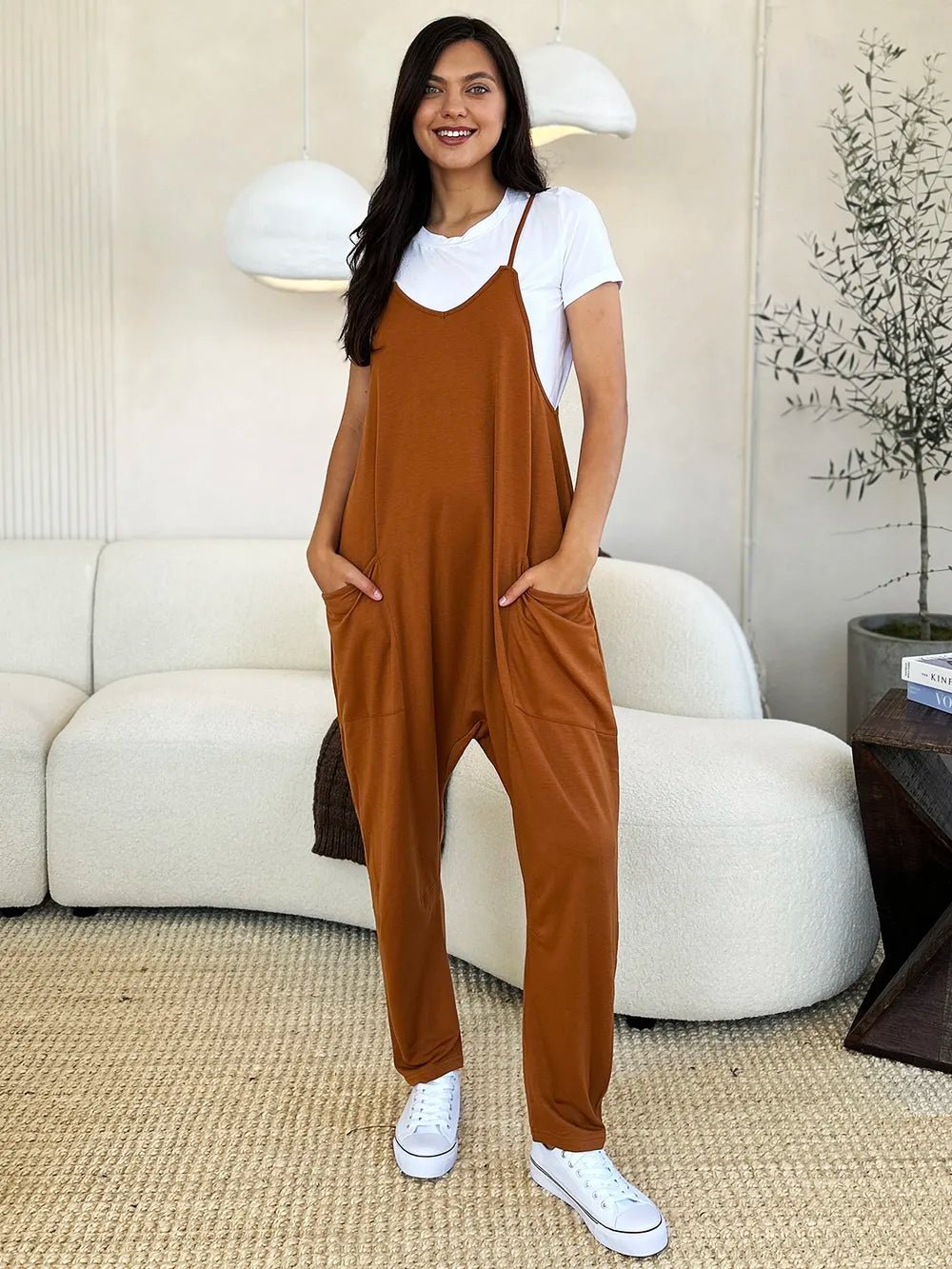 Women’s sleeveless V-neck wide-leg jumpsuit with pockets, trendy and comfortable fashion by Trendsi, shown in full length.