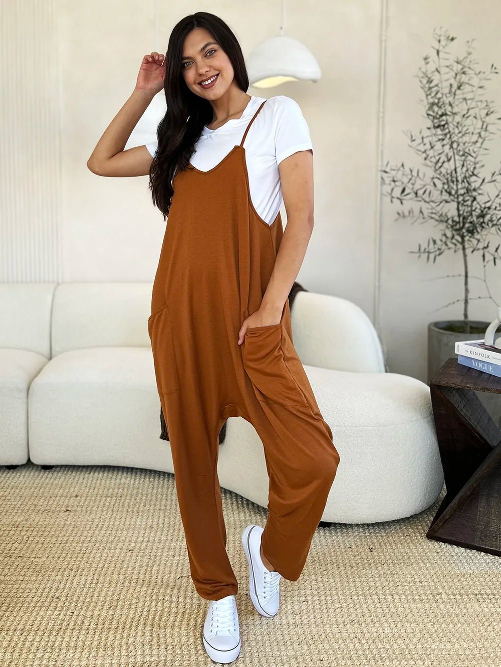 Women's sleeveless V-neck wide-leg jumpsuit with pockets, stylish and comfortable, from Trendsi.