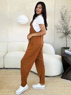 Women's sleeveless V-neck jumpsuit with wide legs and pockets, trendy women's apparel by Trendsi.
