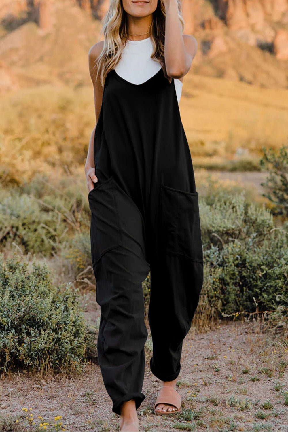 Women’s lightweight V-neck sleeveless jumpsuit with pockets, casual romper from Plush Fashion Hub, full-length front view.