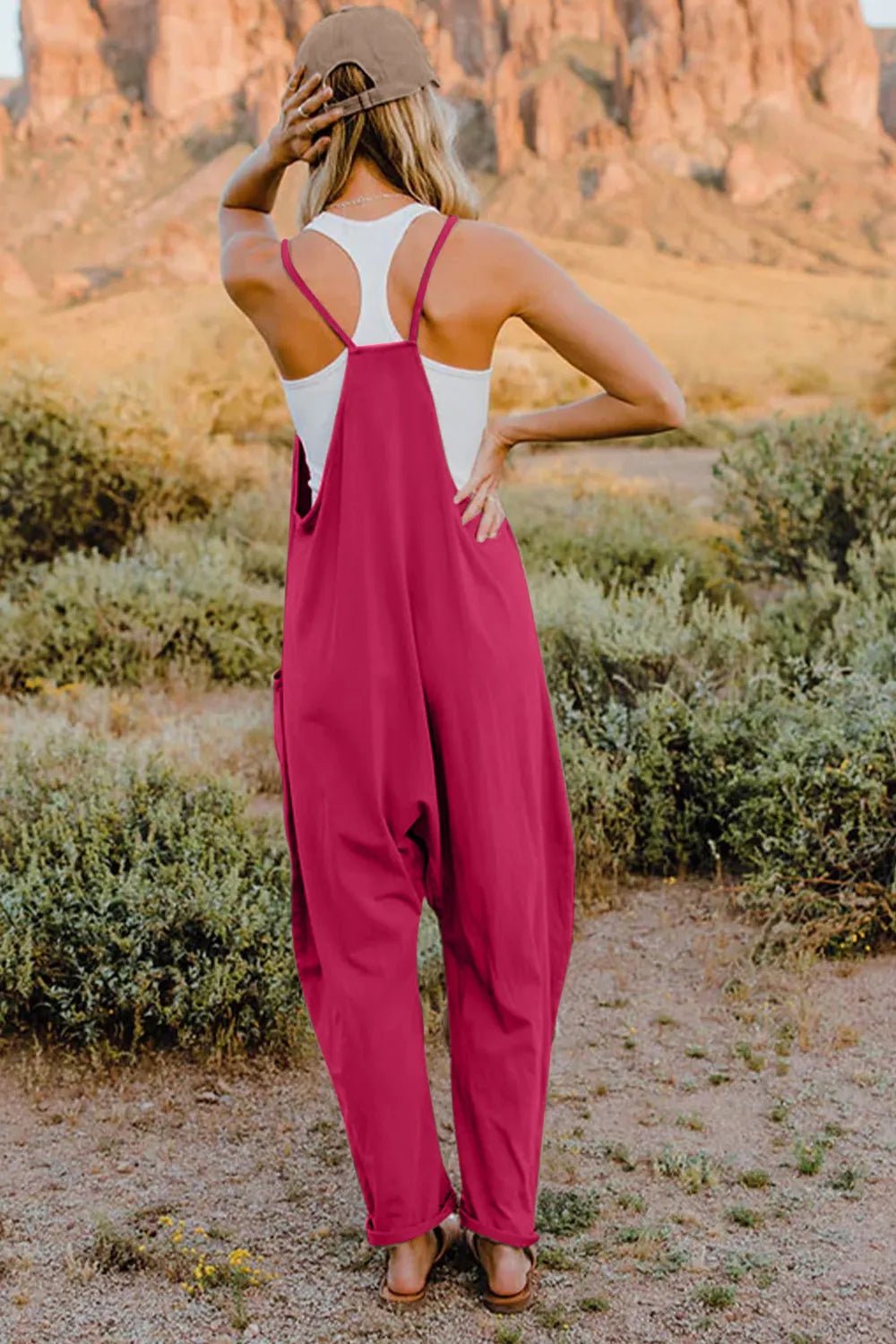 Women's sleeveless V-neck jumpsuit with pockets, lightweight casual romper by Plush Fashion Hub, shown in a full-length view.