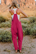 Women's sleeveless V-neck jumpsuit with pockets, lightweight casual romper by Plush Fashion Hub, shown in a full-length view.
