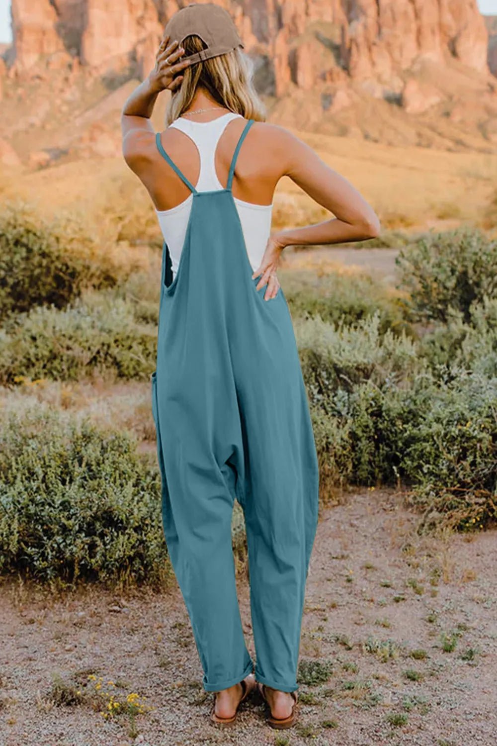 Women's sleeveless V-neck jumpsuit with pockets, lightweight and casual, by Plush Fashion Hub, shown in full length.