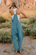 Women's sleeveless V-neck jumpsuit with pockets, lightweight and casual, by Plush Fashion Hub, shown in full length.