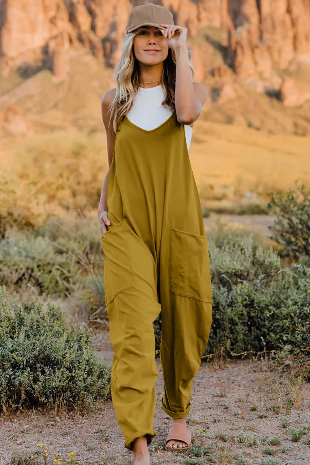 Women's lightweight sleeveless V-neck jumpsuit with pockets, casual romper by Plush Fashion Hub, shown in full length.