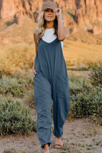 Women's sleeveless V-neck jumpsuit with pockets, lightweight casual romper by Plush Fashion Hub, shown in a full-size front view.