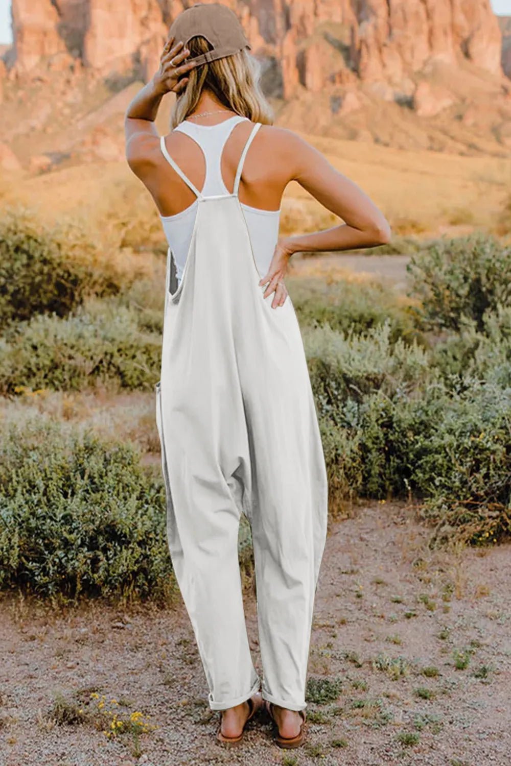 Women's lightweight sleeveless V-neck jumpsuit with pockets, casual romper by Plush Fashion Hub, full-length front view.
