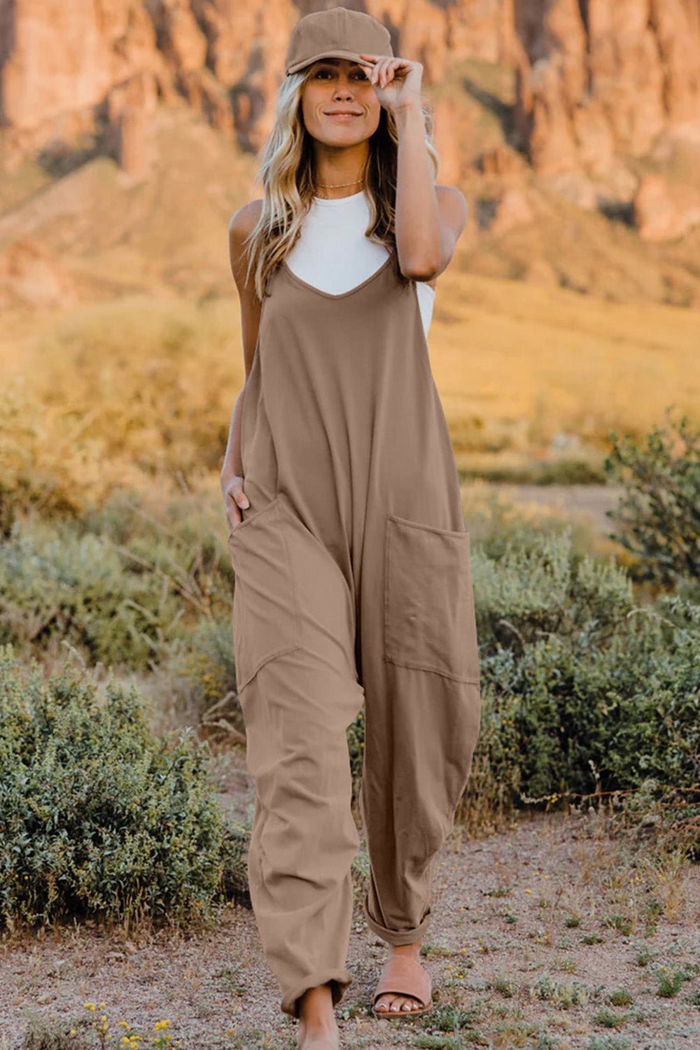 Women’s V-neck sleeveless jumpsuit with pockets, lightweight casual romper by Plush Fashion Hub, perfect for warm-weather wear.