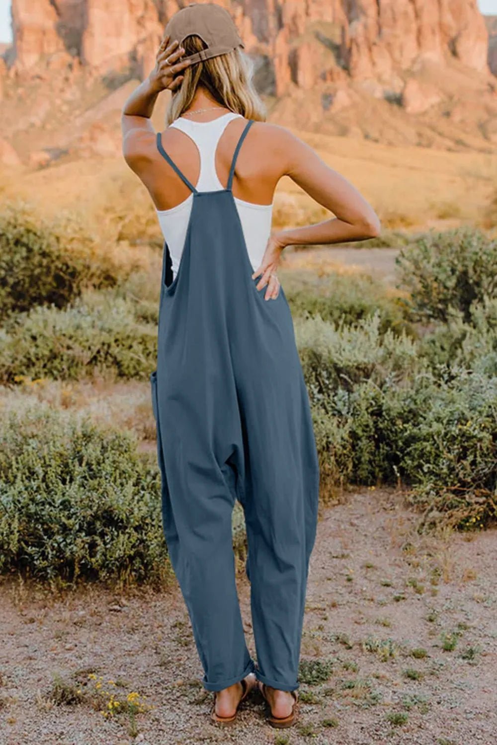 Women's sleeveless V-neck jumpsuit with pockets, lightweight casual romper by Plush Fashion Hub, full-length and comfortable fit.