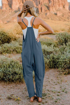 Women's sleeveless V-neck jumpsuit with pockets, lightweight casual romper by Plush Fashion Hub, full-length and comfortable fit.