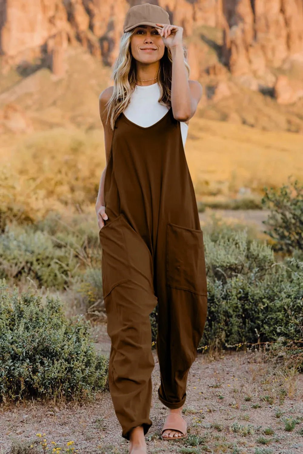 Women’s V-neck sleeveless jumpsuit with pockets, lightweight casual romper by Plush Fashion Hub, shown in a full-length view.