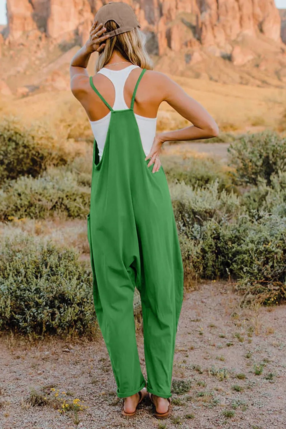 Women’s sleeveless V-neck jumpsuit with pockets, lightweight casual romper by Plush Fashion Hub, full-length and comfortable fit.