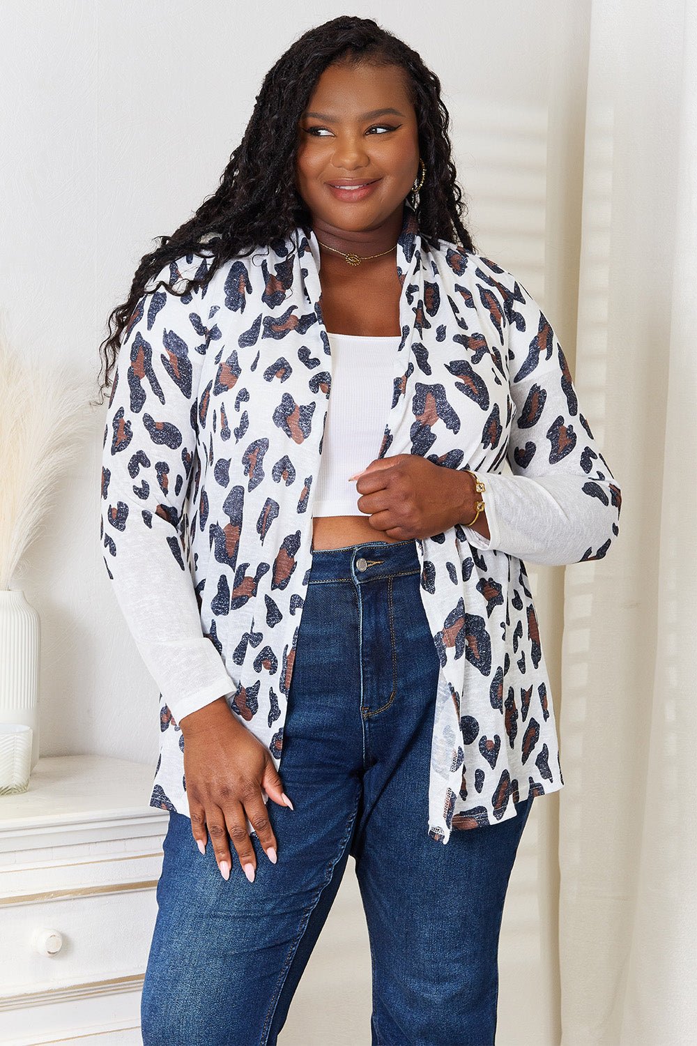Women's leopard print long sleeve knit cardigan by Trendsi, soft layering piece with cozy, stylish leopard design.