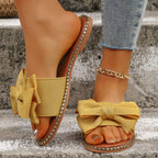 Plush Fashion Hub bowknot embellished flat sandals with open toe design and cushioned sole, stylish for casual wear.