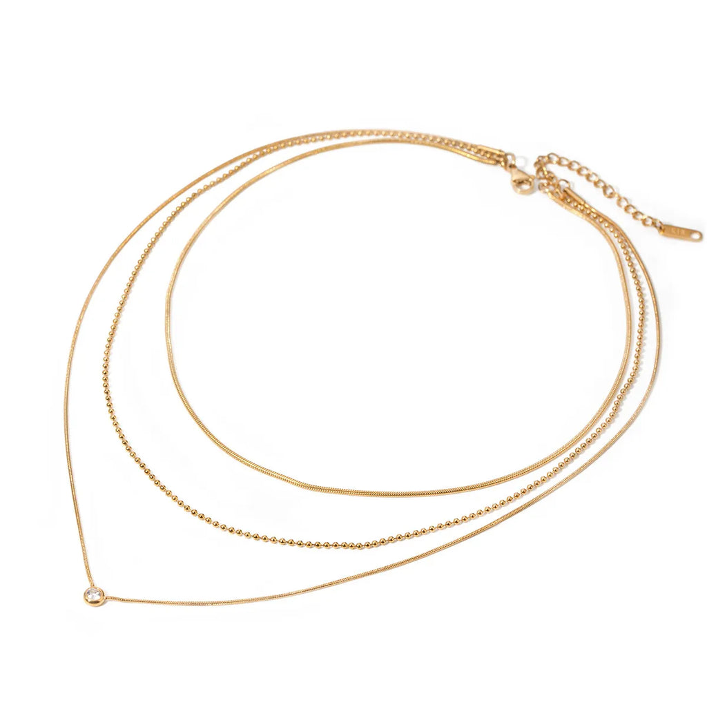 18K gold-plated layered necklace featuring delicate chains and subtle pendant, styled on a white background.