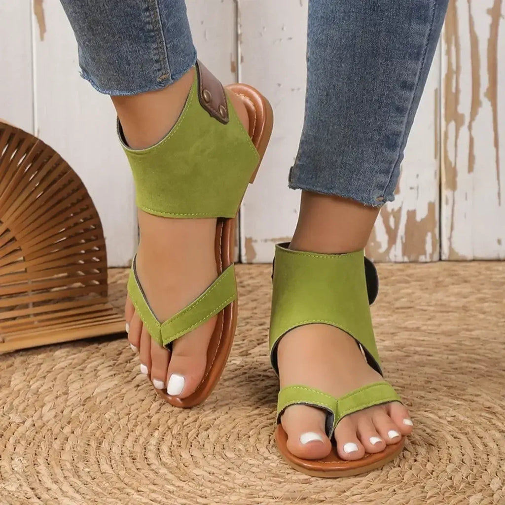 Women's faux leather ankle strap flat sandals by Trendsi, featuring comfortable design and stylish open-toe silhouette.