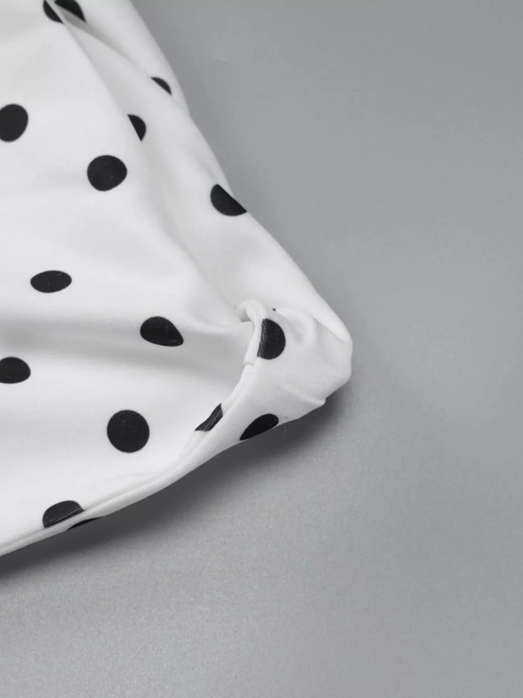 Polka dot sleeveless mini dress with bow accents by Shopimist, featuring a fitted silhouette and playful pattern.