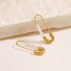 Shopimist safety pin earrings with pearl accents, featuring modern jewelry design and elegant pearl details.