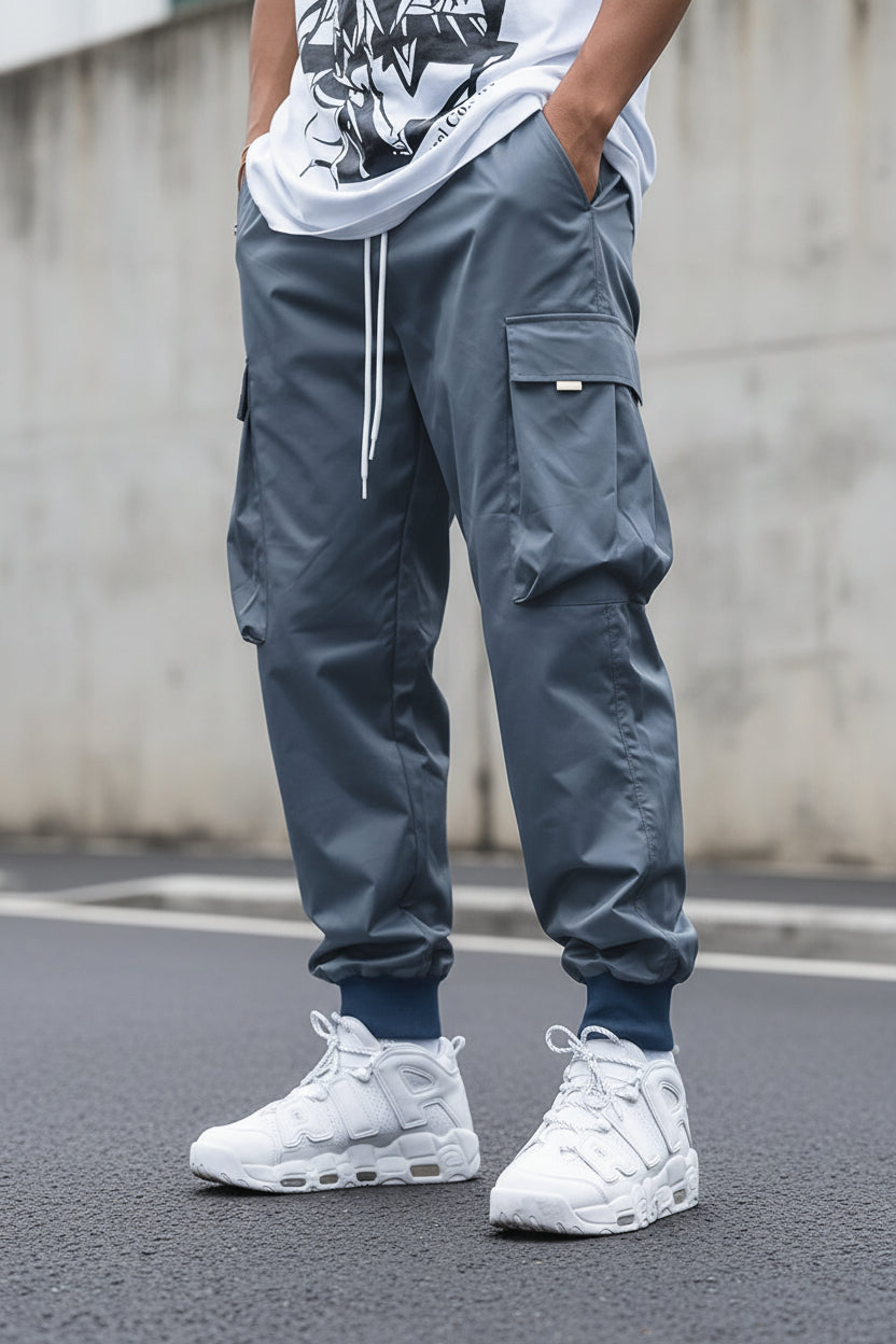 Men’s multi-pocket cargo pants in streetwear style with drawstring waist, featuring multiple utility pockets, by Plush Fashion Hub.