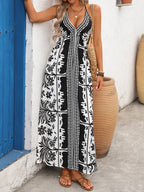 Women's printed halter neck maxi dress with tie-back detail from Plush Fashion Hub, featuring flowy fabric and vibrant pattern.