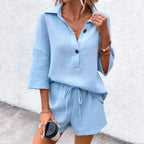 Women's two-piece set by Plush Fashion Hub featuring a notch-lapel short-sleeve top and belted shorts, stylish and comfortable.