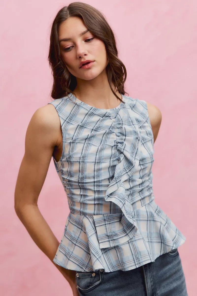 Plaid sleeveless ruffle peplum top by Plush Fashion Hub, featuring a stylish pattern and feminine design.