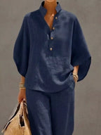 Plus size women's two-piece set featuring a button-detail 3/4 sleeve top and matching pants, stylish dress from Trendsi.