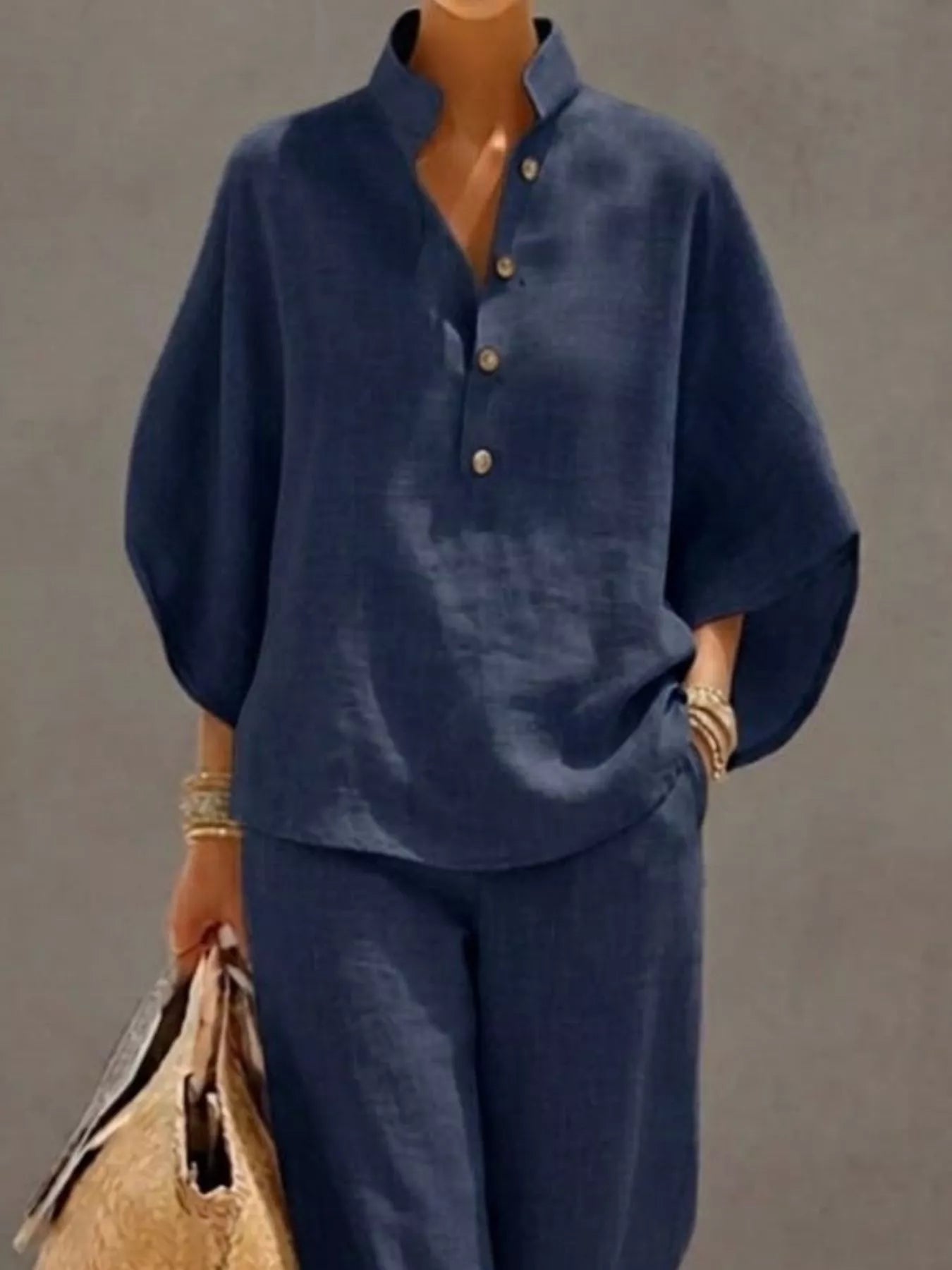 Plus size women's two-piece set featuring a button-detail 3/4 sleeve top and matching pants, stylish dress from Trendsi.