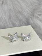 Butterfly pearl stud earrings by Shopimist featuring classic white pearls and delicate butterfly-shaped designs.