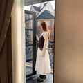 FitiqueFit relaxed A-line cotton midi skirt with crushed pleats and belt, casualwear style, shown on a model.