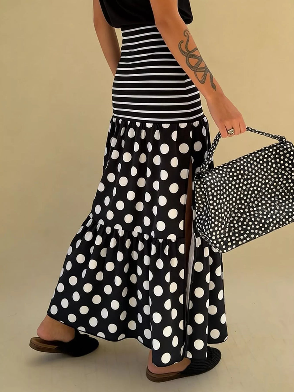 Flowy women's polka dot and striped slit maxi skirt by Trendsi, featuring a casual bohemian style with a relaxed fit and lightweight fabric.