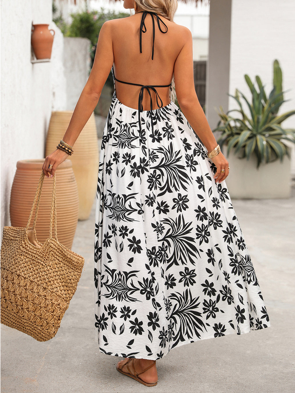 Women's printed halter neck maxi dress with tie-back detail from Plush Fashion Hub, featuring a flowing design and vibrant pattern.