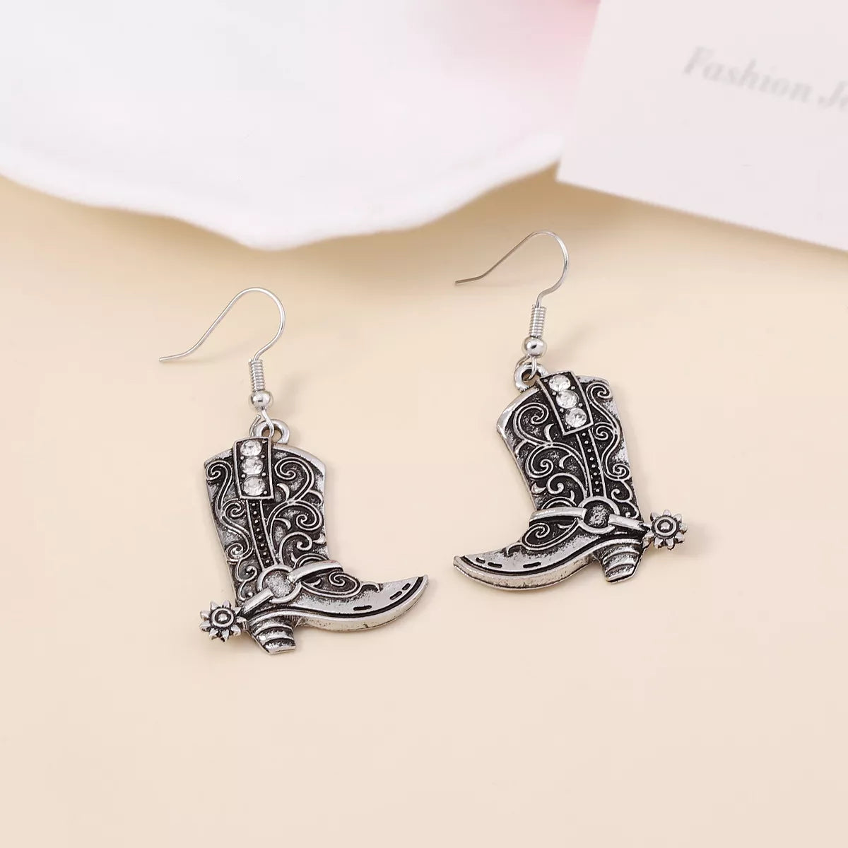 Vintage Western cowboy boot dangle earrings in gold tone with intricate detailing, stylish accessory for Western-inspired fashion.