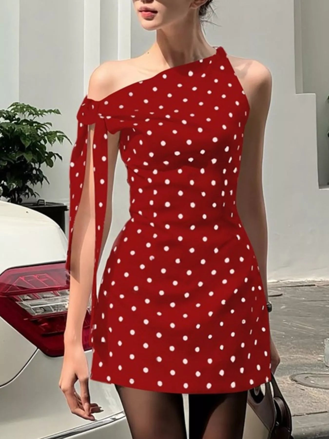 Polka dot sleeveless mini dress with bow accents by Shopimist, featuring a fitted bodice and playful polka dot pattern.