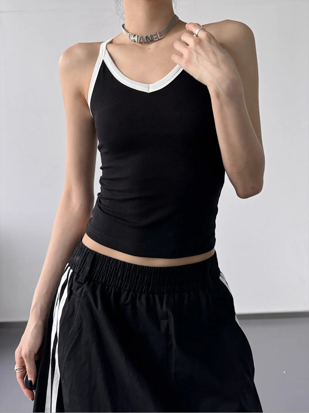 Contrast trim cami top from Trendsi featuring a sleek, fitted design with contrasting trim details, perfect for casual or layered looks.