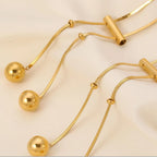 18K gold-plated titanium steel hollow bead necklace with shiny spherical beads, elegant jewelry accessory.