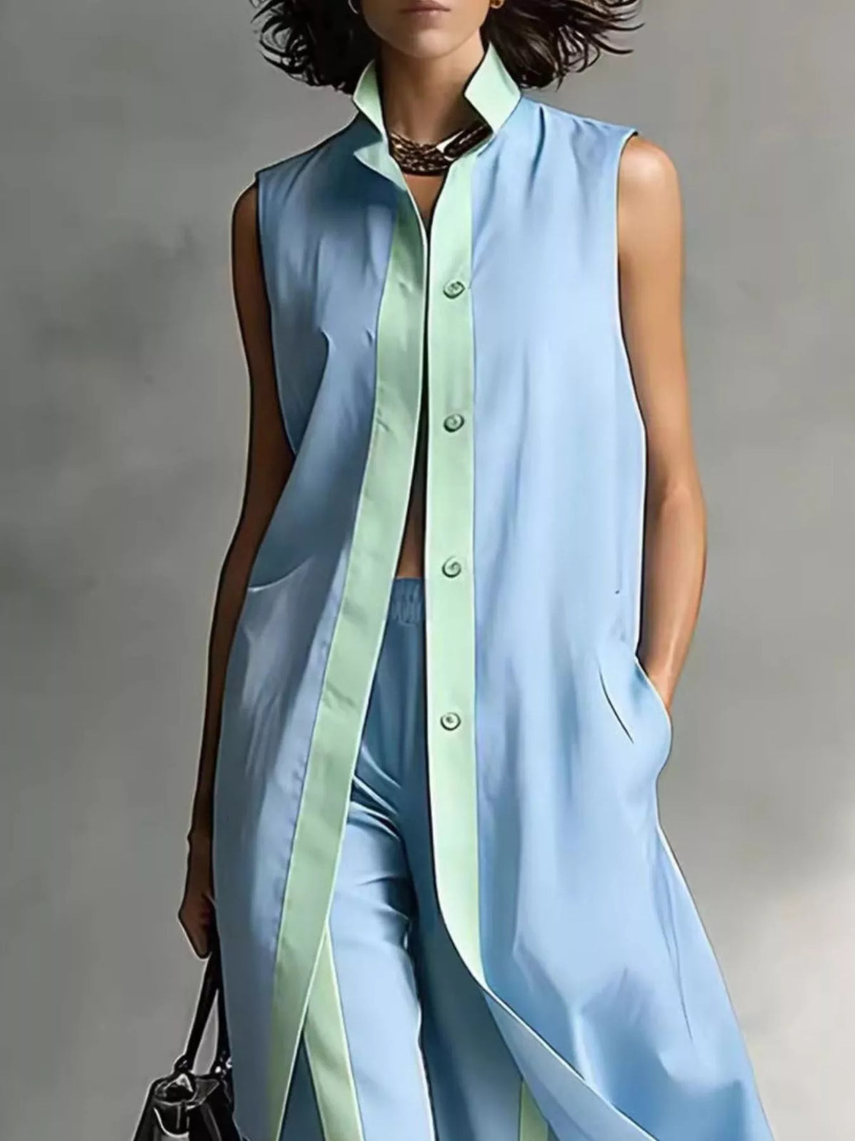 Plus size full sleeveless longline vest and wide leg pants matching set from Trendsi, featuring a stylish sleeveless vest and flowing pants.