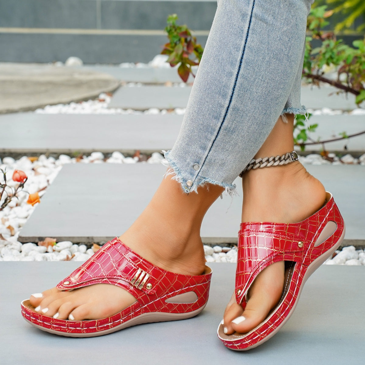 Women's faux leather wedge sandals with toe post and mid-heel, featuring a stylish design and comfortable fit.