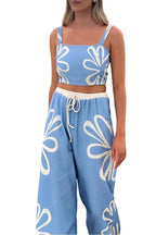 Smocked square neck cami and pants loungewear set by Trendsi featuring a coordinated soft fabric in neutral tones.