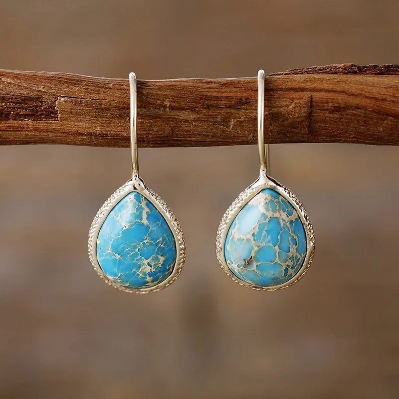 Copper natural stone teardrop earrings with polished finish, showcasing elegant jewelry design and craftsmanship.