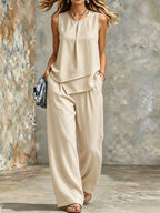 Women's sleeveless two-piece set by FitiqueFit featuring solid color wide-leg pants and matching sleeveless top.