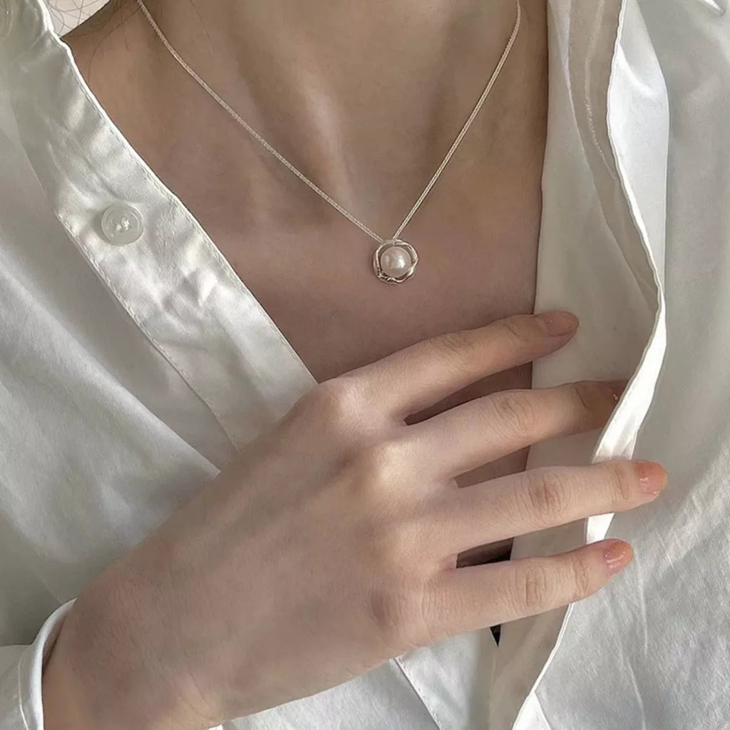 Sterling silver pearl pendant necklace featuring a lustrous white pearl on a delicate chain, crafted by Shopimist.