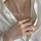 Sterling silver pearl pendant necklace featuring a lustrous white pearl on a delicate chain, crafted by Shopimist.