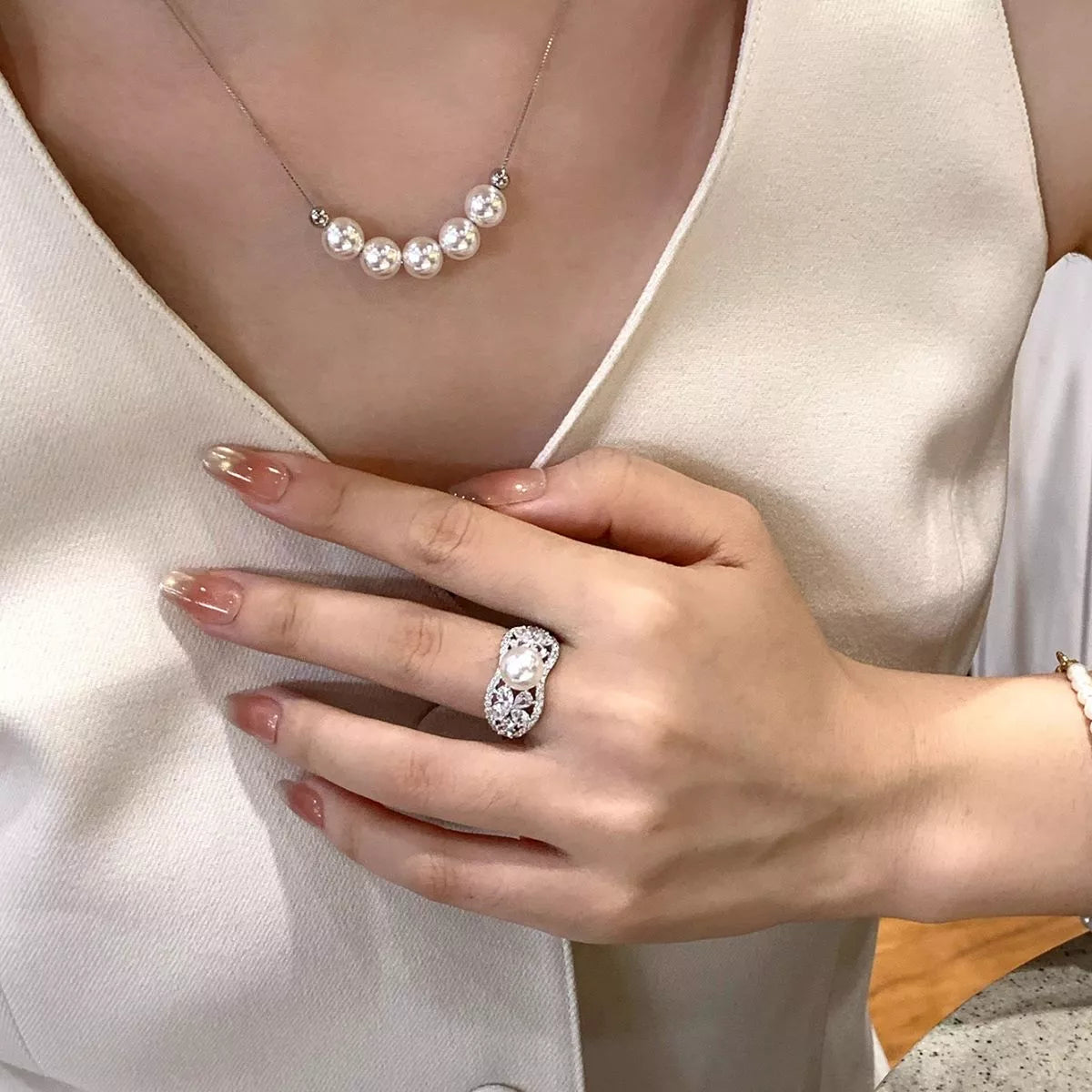 Adjustable pearl necklace with classic white pearls and silver clasp, featuring a versatile design by Plush Fashion Hub.