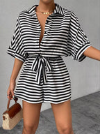 Striped button-up belted romper jumpsuit by Trendsi featuring a sleeveless design and waist tie, perfect for casual wear.