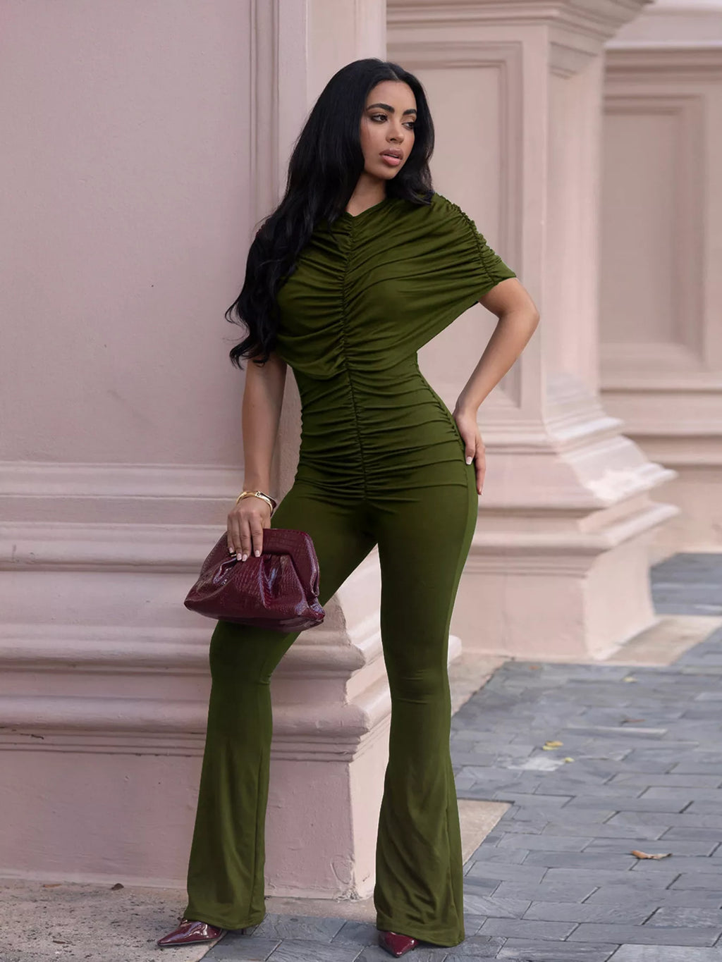 Ruched flare leg jumpsuit from Trendsi featuring a fitted bodice and wide-leg design, displayed on a mannequin.