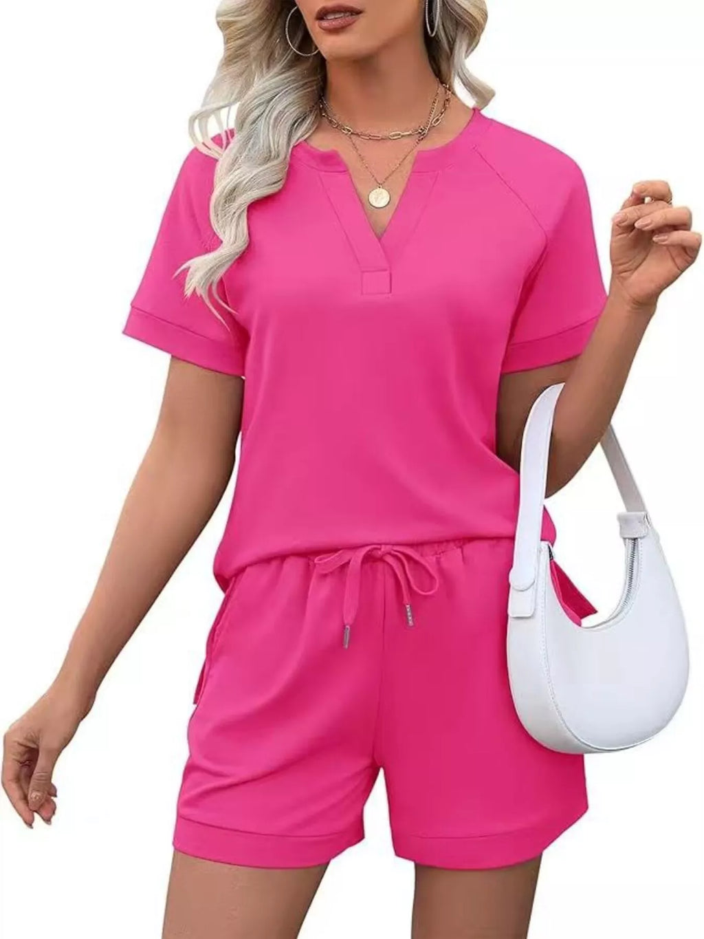 Solid color short sleeve top and shorts two-piece set by Trendsi, casual and comfortable for warm weather.