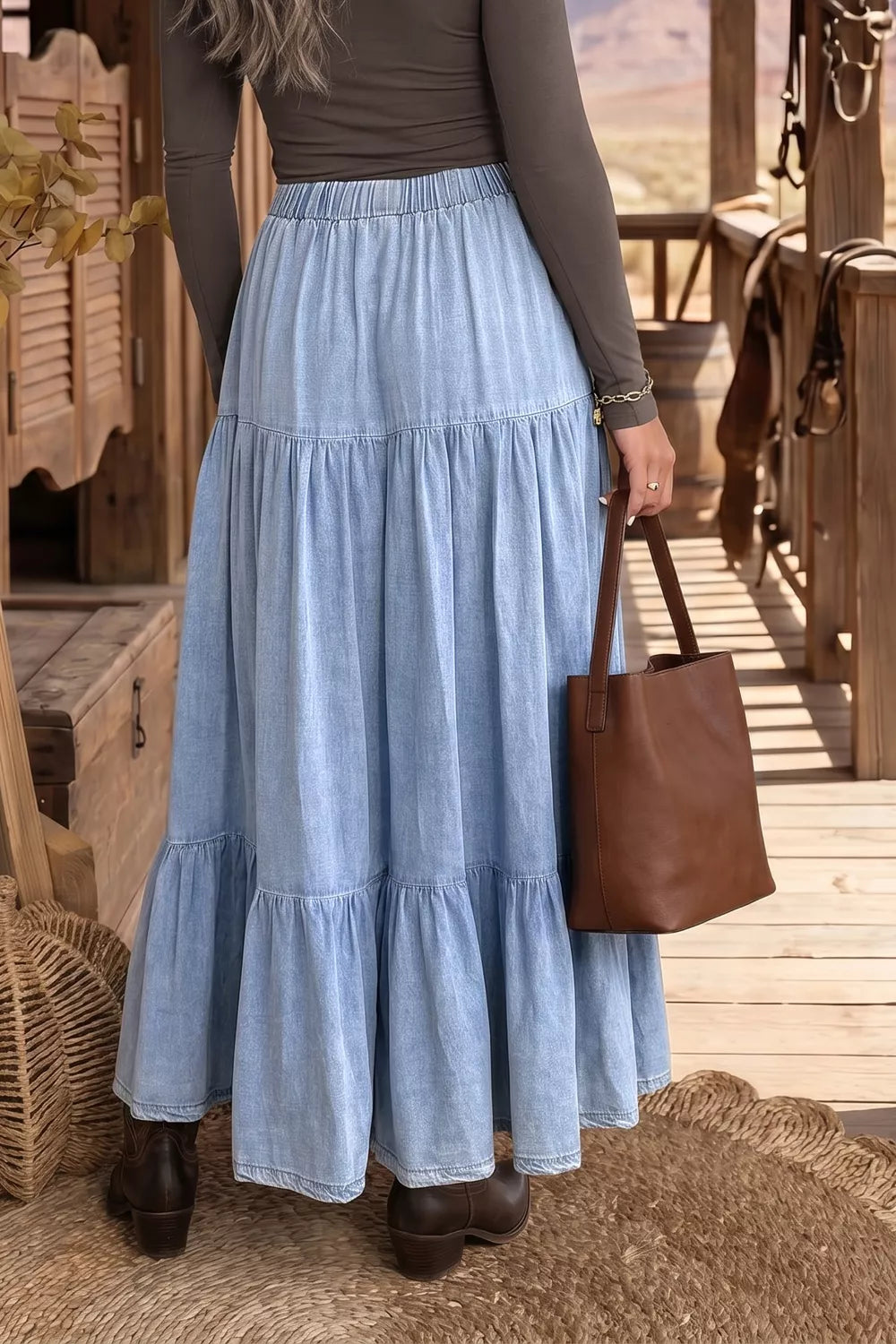 Plush Fashion Hub elastic waist ruffled tiered flared denim maxi skirt displayed on a model with a casual background.