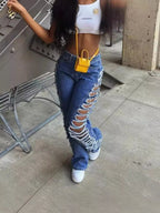 Pair of plush fashion hub side distressed denim jeans showing ripped details and classic fit in a natural pose